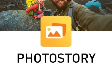 A man and a young girl wearing backpacks are smiling and taking a selfie on a rocky mountain landscape with a lake visible below. The image is part of an advertisement for "MAGIX Photostory Deluxe v24.0.1.184," featuring a yellow icon with overlapping photo outlines.